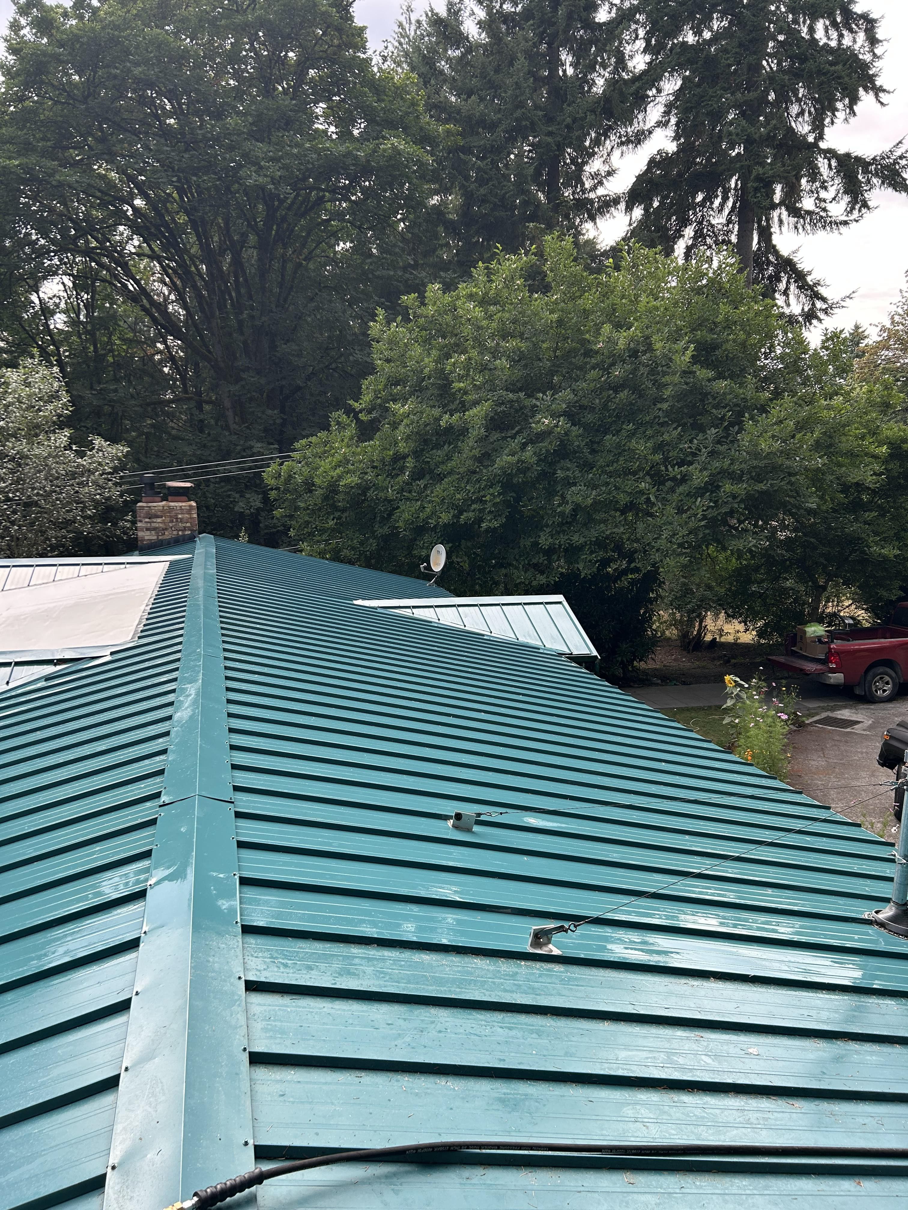 Metal roof after cleaning - vibrant teal finish